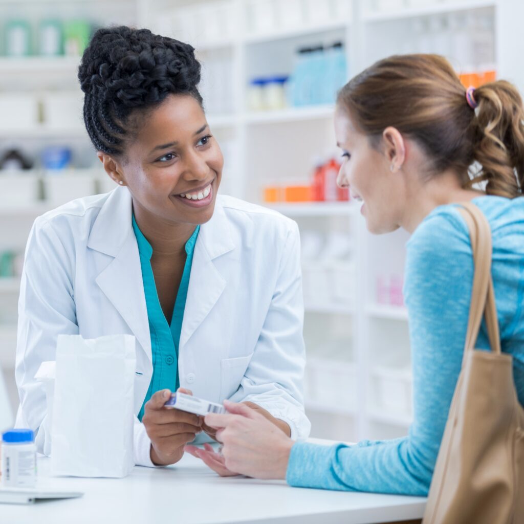 pharmacist talking to a customer over the counter